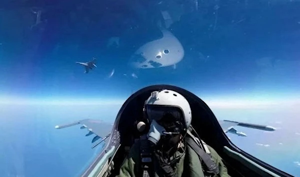 A pilot is photographed operating an aircraft of the Air Force under PLA during a combat readiness patrol at an undisclosed location in this handout image released on April 8, 2023. (REUTERS)