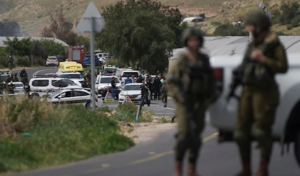 Israeli occupation forces examine the scene of a shooting near the Israeli settlement of 'Hamra' in West Bank, April 7, 2023 (AP)