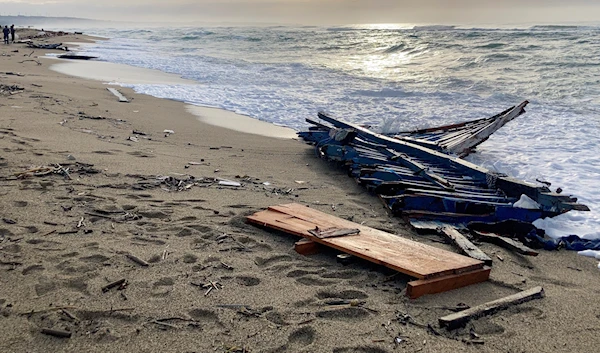 A view of part of the wreckage of a capsized boat that was washed ashore at a beach near Cutro, southern Italy, on Feb. 27, 2023. (AP)