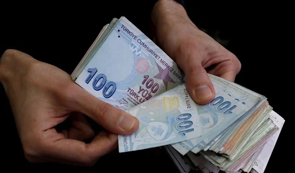 A merchant counts Turkish lira banknotes at the Grand Bazaar in Istanbul, Turkey, March 29, 2019 (Reuters)