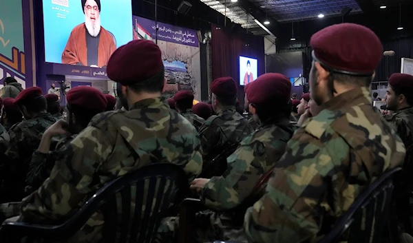 Hezbollah fighters listen to Secretary-General leader Sayyed Hassan Nasrallah who is speaking via a video link during a rally to mark Al-Quds Day, in a southern suburb of Beirut, Lebanon, April 14, 2023 (AP)