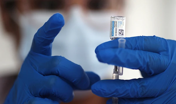 A nurse draws from a vial of Johnson & Johnson coronavirus disease (COVID-19) vaccine, in Los Angeles, California, US, March 25, 2021. (AP)