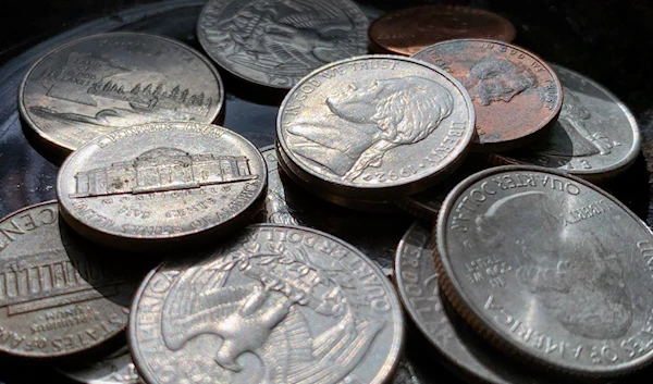 Quarters, nickels, dimes and pennies are held a bowl Thursday, March 31, 2022, in Tigard, Oregon. (AP)