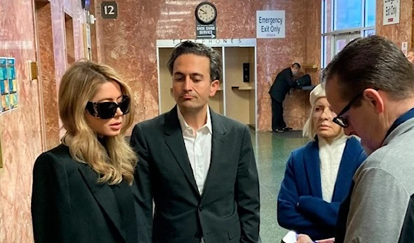 Khazar Elyassnia stands alongside her husband Dino Elyassnia, at the Hall of Justice in San Francisco where her brother was scheduled to appear after being charged with the murder of Bob Lee on Friday, 14 April 2023 . (AP)