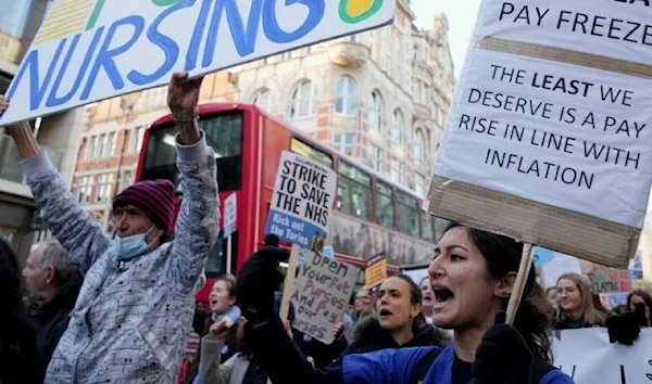 NHS nurses march during a strike, amid a dispute with the government over pay, in London, Britain December 20, 2022. (REUTERS)