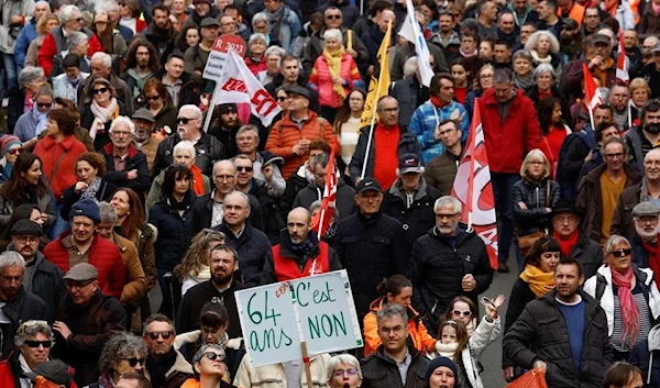 Protesters take part in a demonstration against the French government's pension reform plan, as part of the eighth day of national strike and protests, in Ancenis-Saint-Gereon, France, March 15, 2023 (Reuters)