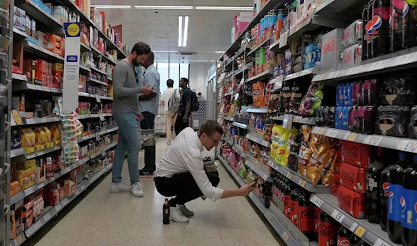 Shoppers purchase food in a supermarket in London. (AP)