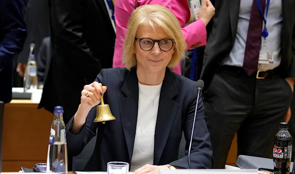 Sweden's Finance Minister Elisabeth Svantesson rings a bell to signify the start of a meeting of EU finance ministers at the European Council building in Brussels on Tuesday, March 14, 2023. (AP)