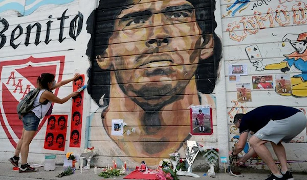 People gather to mourn the death of soccer legend Diego Armando Maradona, outside the Diego Amrando Maradona stadium, in Buenos Aires, Argentina, November 25, 2020. (Reuters)