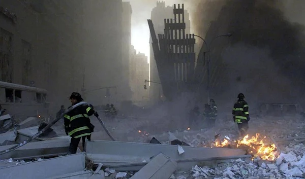 Firefighters work around the World Trade Center after both towers collapsed in New York on September 11, 2001. (Reuters)