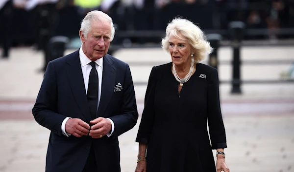 Britain's King Charles and Queen Camilla walk along the fence of Buckingham Palace, following the passing of Britain's Queen Elizabeth, in London, Britain, September 9, 2022 (Reuters)