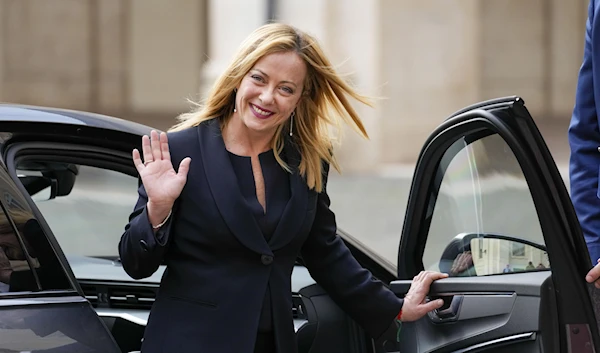 Italian Premier Giorgia Meloni waves to cameras as she leaves after swearing in at Quirinal presidential palace, Saturday, Oct. 22, 2022. (AP)