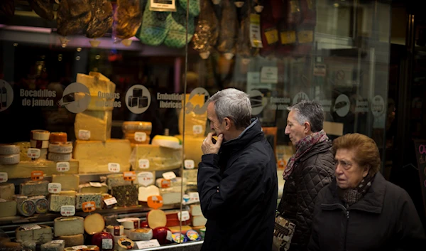 A man check prices of food in a shop window, in Madrid, Friday, Dec. 21, 2012. (AP)