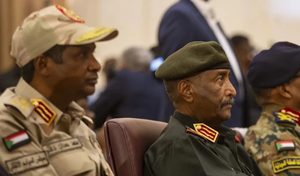 Gen. Mohamed Hamdan Dagalo, known as Hemedti (left), and Gen. Abdel Fattah al-Burhan (center) at the signing of the framework agreement in December 2022. (AP)