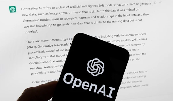 The OpenAI logo is seen on a mobile phone in front of a computer screen displaying output from ChatGPT, Tuesday, March 21, 2023, in Boston (AP Photo/Michael Dwyer, File)