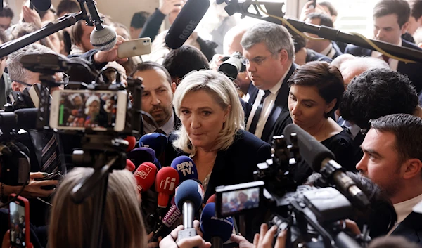 French far-right leader Marine Le Pen speaks to medias at the National Assembly in Paris, Thursday, March 16, 2023 (AP)