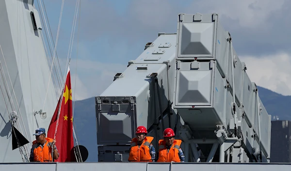 Chinese People's Liberation Army (PLA) Navy sailors stand on the deck of the Qinzhou guided-missile frigate in Hong Kong, China, September 8, 2021 (AP)