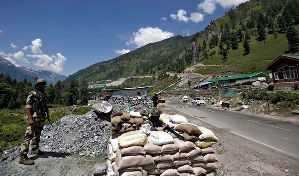 India's Border Security Force (BSF) soldiers stand guard at a checkpoint along a highway that leads to the Ladakh, at Gagangeer in Kashmir's Ganderbal district, 17 June 2020. (Reuters)