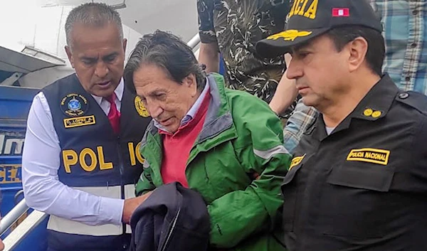 In this photo released by Peru's National Police officers escort former President Alejandro Toledo upon his arrival, extradited from the United States, to the airport in Lima, April 23, 2023 (AP)