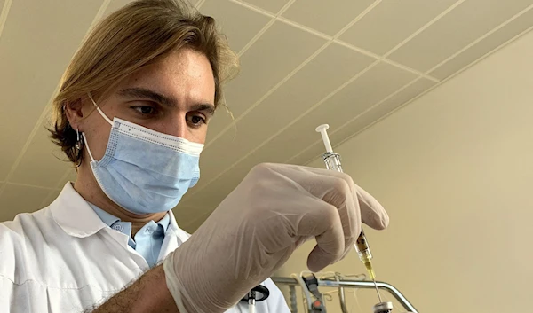 Nurse prepares a new generation COVID-19 vaccine administered via an arm patch during a Phase I clinical study, Switzerland, January 19, 2022. (REUTERS)