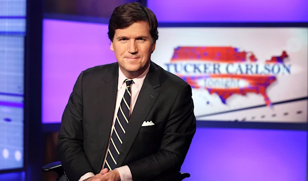 Tucker Carlson, host of "Tucker Carlson Tonight," poses for photos in a Fox News Channel studio on March 2, 2017, in New York. (AP)