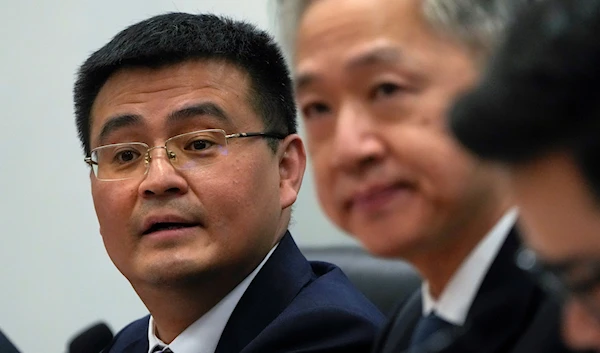 Deputy Director of Department of Eurasia of Ministry of Foreign Affairs Yu Jun, left, speaks during a news conference in Beijing, China, April 26, 2023 (AP)