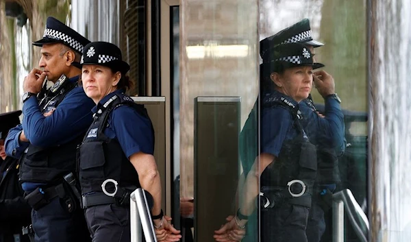 Two police officers stand outside the New Scotland Yard, London, UK, 21 March 2023. (Reuters)