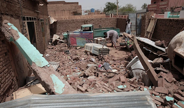 A man cleans debris of a house hit in recent fighting in Khartoum, Sudan, Tuesday, April 25, 2023. (AP)