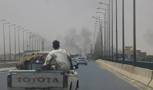 Smoke rises near Halfaya Bridge between Omdurman and Khartoum North on 15 April 2023. (REUTERS)