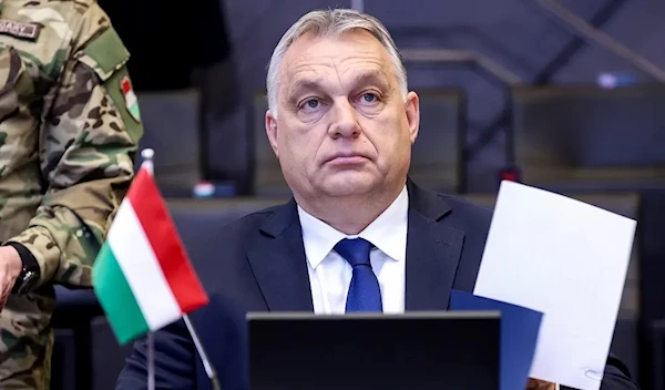 Hungary’s Prime Minister Viktor Orban attends a NATO video summit on Russia’s invasion of the Ukraine at the NATO headquarters in Brussels on February 25, 2022. (AFP)