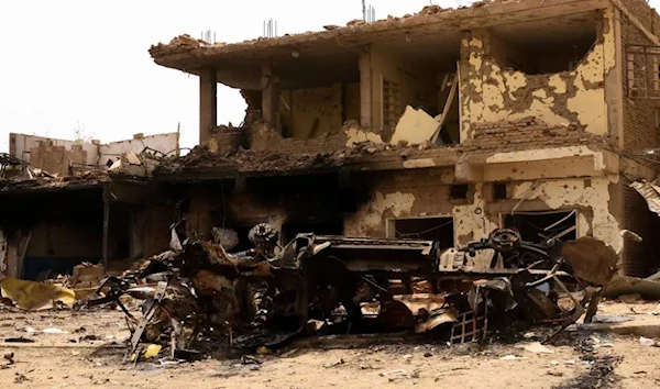 A damaged car and buildings at the central market during clashes between the paramilitary Rapid Support Forces and the army in Khartoum North, Sudan, on April 27, 2023. (Reuters)