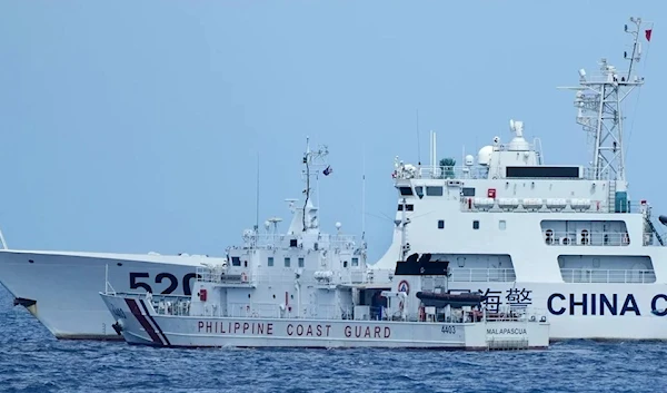 A Philippine patrol vessel neared a Chinese coast guard ship (5201) on Sunday, causing a near-collision in the South China Sea. (AP)