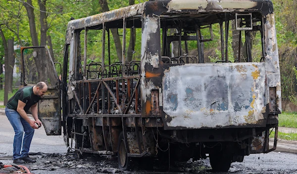 A view shows a burnt-out minibus hit by shelling in the course of Russia-Ukraine conflict in Donetsk, Russian-controlled Ukraine, April 28, 2023 (Reuters)