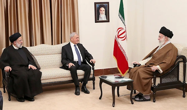 Iranian Leader Ayatollah Ali Khamenei, right, meets Iraqi President Abdul Latif Rashid, center, as Iranian President Ebrahim Raisi sits at the left, in Tehran, Iran, April 29, 2023 (AP)