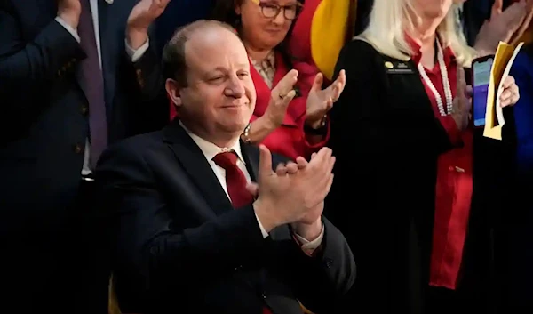 Jared Polis applauds a speaker before signing four gun control bills. (AP)