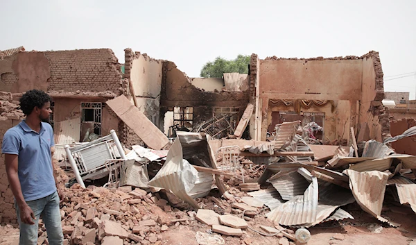 A man walks by a house hit in recent fighting in Khartoum, Sudan, April 25, 2023 (AP)