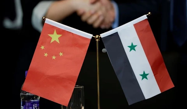 Syrian and Chinese displayed in conjunction during a meeting between Syrian and Chinese individuals to discuss recontracution efforts in Syria, Beijing, China, 8 May 2017. (Reuters)