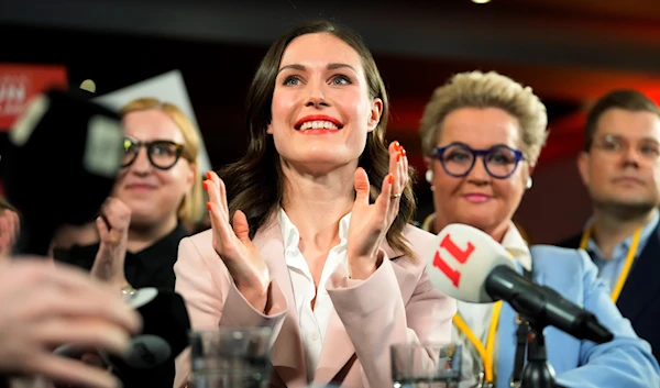 Finnish Prime Minister Sanna Marin, Social Democratic Party chair, center, reacts as she watches results of exit polls in Helsinki, Finland, Sunday, April 2, 2023. (AP)