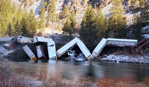 Products could be seen spilling out of at least one rail car in the Sunday derailment, which involved around 25 cars, officials said. (AP)