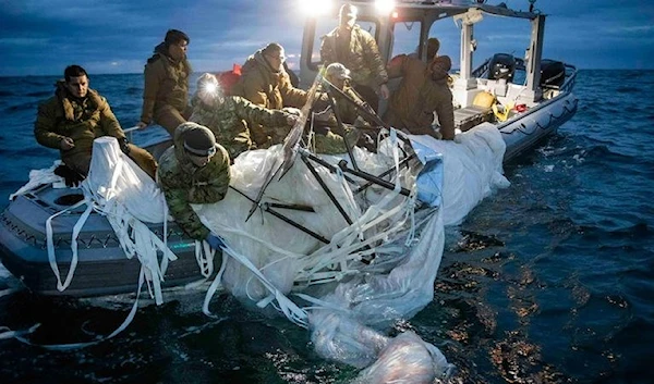 US Navy experts recover the high-altitude Chinese surveillance balloon off the coast of Myrtle Beach, South Carolina,February 2023 (AP)