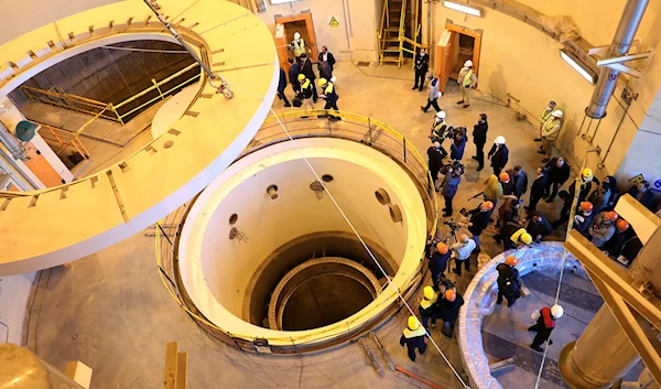 Technicians work at the Arak heavy water reactor's secondary circuit, as officials and media visit the site, near Arak, Iran, December 23, 2019 ((Atomic Energy Organization of Iran via AP)