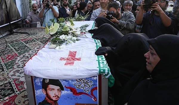 Muslim women shedding tears and paying their respect to the martyr Johnny Bet Oshana,  during the funeral ceremony in Tehran on April 28, 2023, who was martyred during the Iran-Iraq war in 1985. (Tasnim)