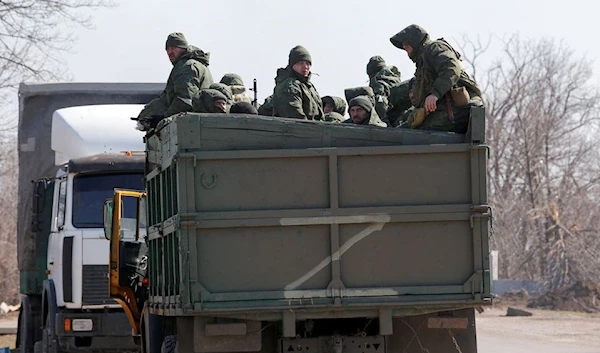 Russian troops riding in a truck near the city of Mariupol, Russia. 21 March 2022. (Reuters)