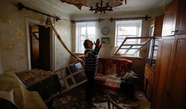 Local resident Marina Sandei, 58, reacts inside her house destroyed by the Ukrainian shelling that targeted Bryansk region on April 29, 2023. (AP)