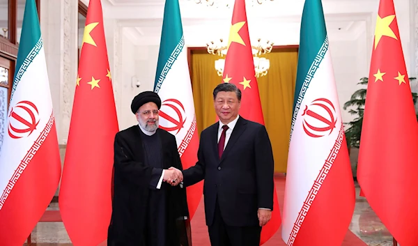 Iranian President Ebrahim Raisi shakes hands with his Chinese President Xi Jinping at the start of the official welcoming ceremony in Beijing, People's Republic of China, 14 February 2023. Handout of the Iranian Presidency Office (AP)