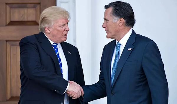 Mitt Romney shakes then President Donald Trump's hand, in November 2016. (AFP)