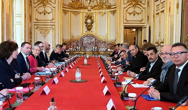 Inter-unions representatives and PM Elisabeth Borne pose prior to talks at Hotel de Matignon in Paris, France, 5 April 2023. (Reuters)