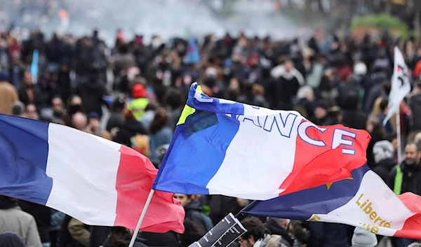 Flags are seen during a demonstration as part of the tenth day of nationwide strikes and protests against French government's pension reform in Paris, France in March 2023 (AFP)