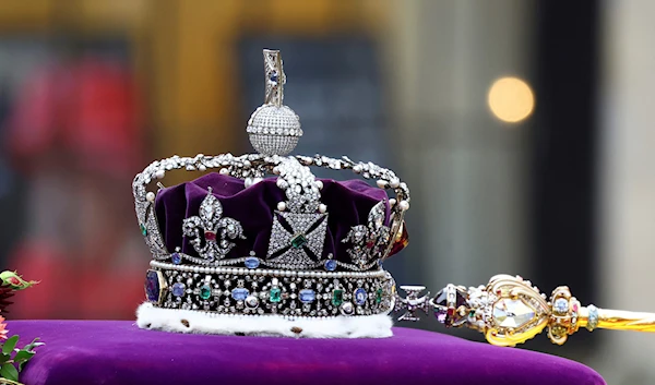 The crown lies on the coffin of Britain's Queen Elizabeth II as it is carried into the Westminster Abbey, during her funeral in London Monday, Sept. 19, 2022. (AP)