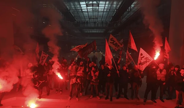 French railway workers storm Centorial building, which is house to US BlackRock offices in Paris, lighting up flares in protests of their government's pension reform plan,France, 6 April 2023. (AP)